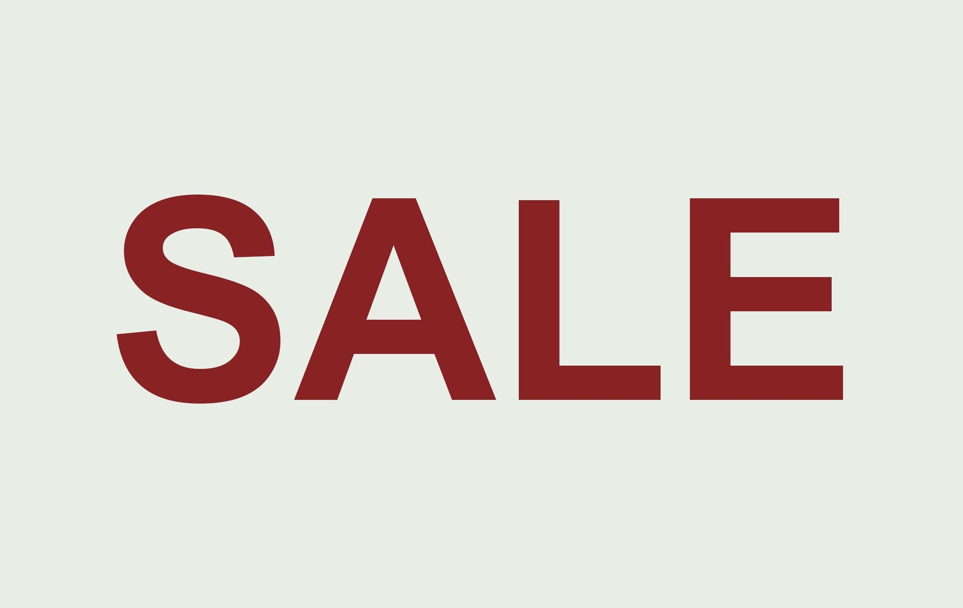 Roter SALE Schriftzug mit Prozentzeichen auf hellem grauen Hintergrund für Wohnaccessoires Sale Kollektion